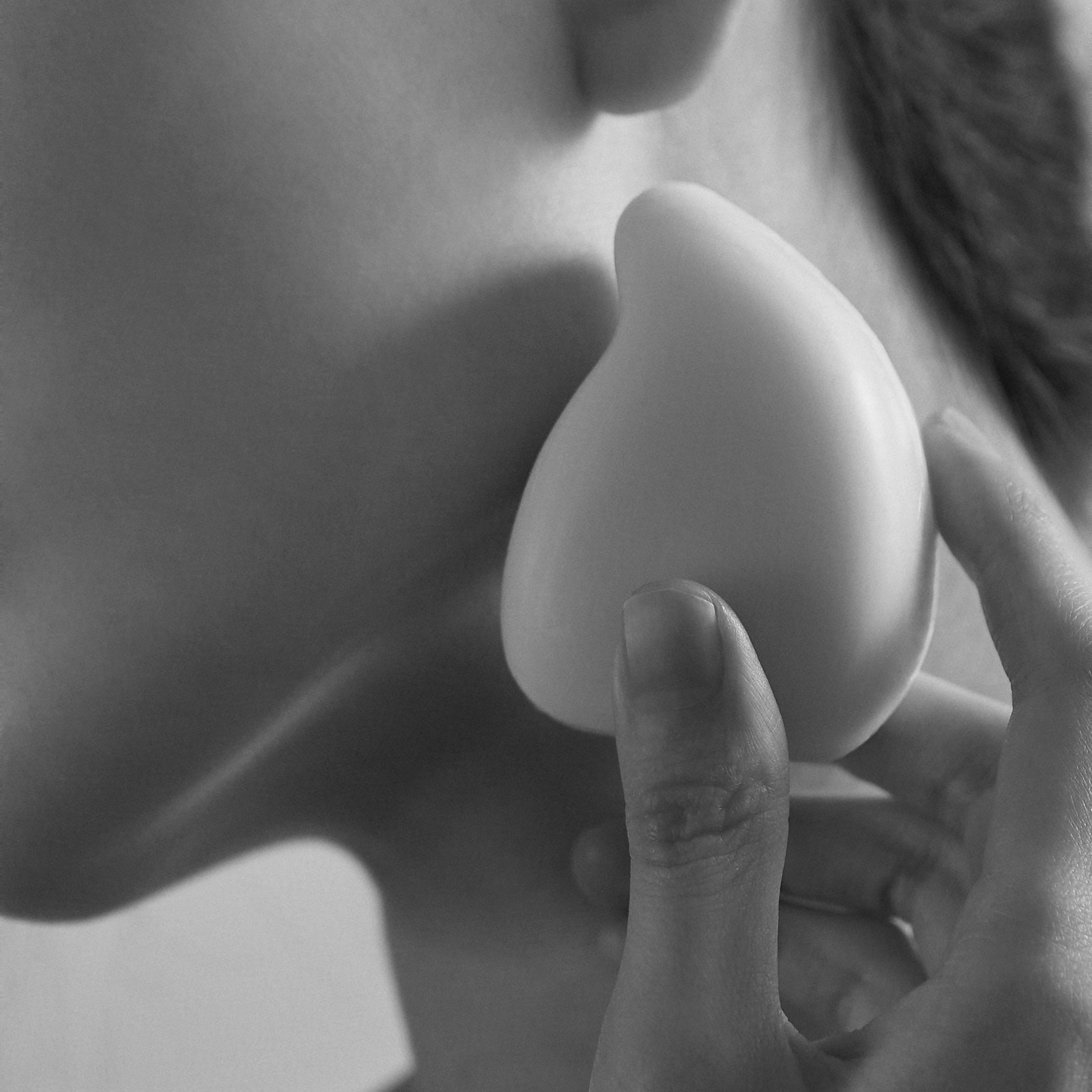 Holding the ReSaltZ salt massage cleansing bar, demonstrating how to perform a Gua Sha massage using the soap&