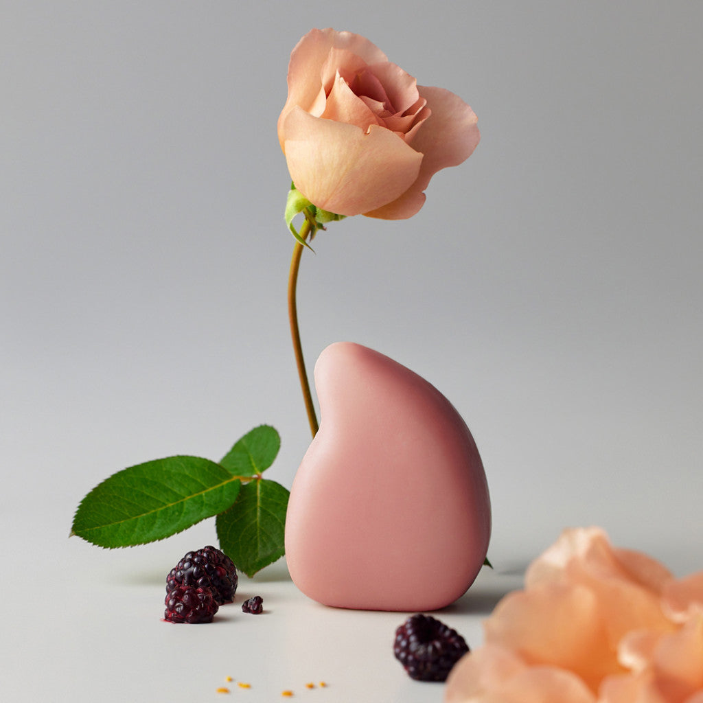 ReSaltZ salt massage cleansing bar in Rosé, with pink rose petals creating a harmonious pink arrangement.
