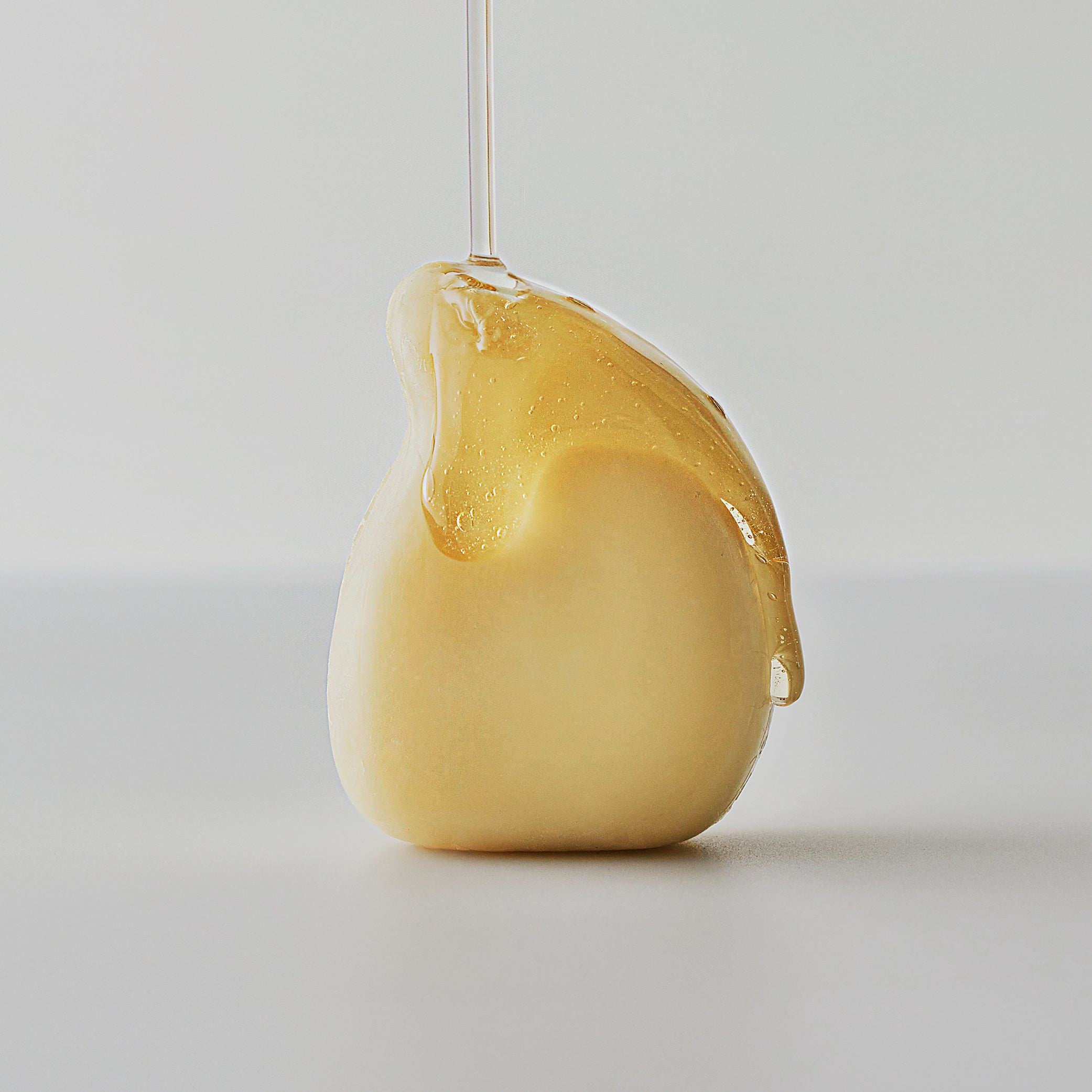 Natural organic oils flowing down the Salt Massage Hair Conditioning Bar