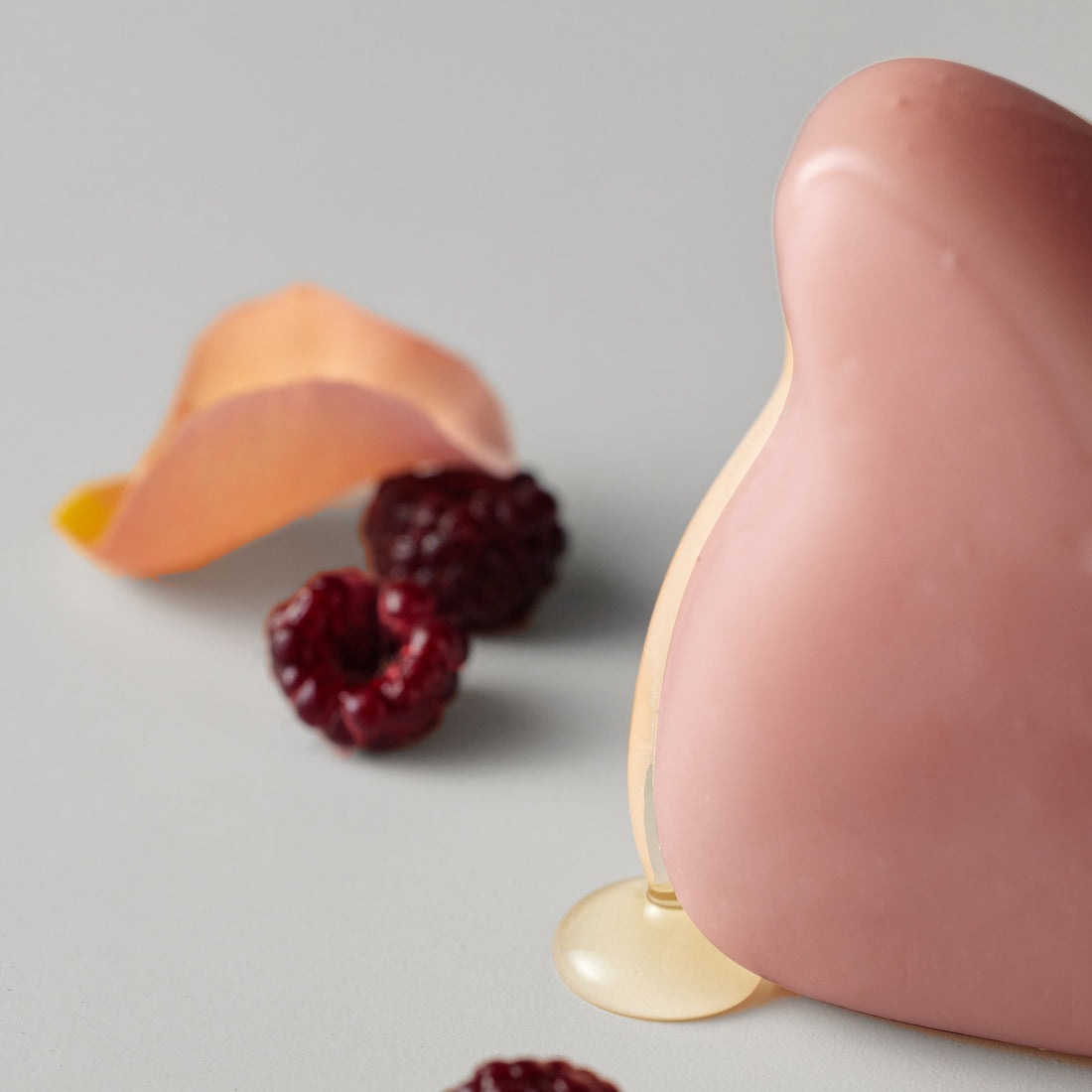 ReSaltZ salt massage cleansing bar in Rosé, with organic oil generously poured over it and flowing down onto the floor