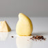 Teardrop-shaped yellow hair conditioner bar made with natural organic oils. The product is designed to deeply nourish and condition hair, shown next to small pieces of ingredients.
